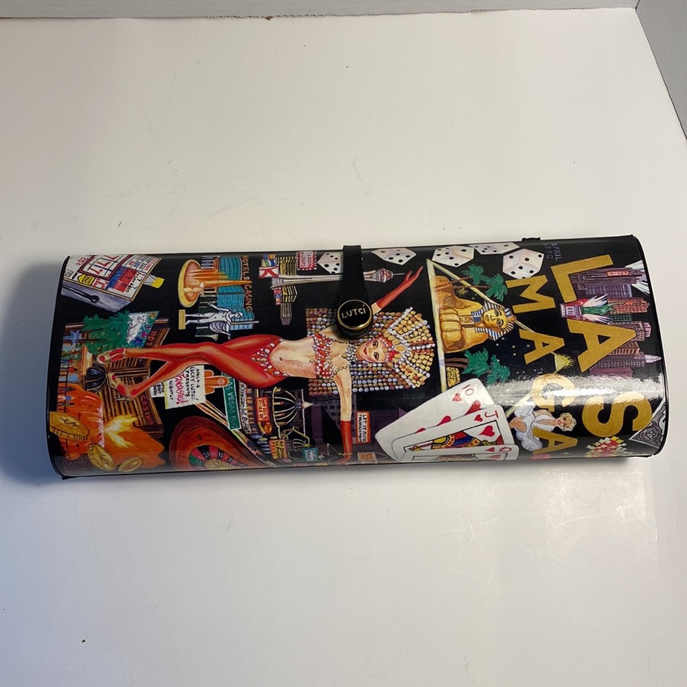 Lutci "Las Vegas Magazine" clutch/shoulder bag depicts Las Vegas casino scenes.
